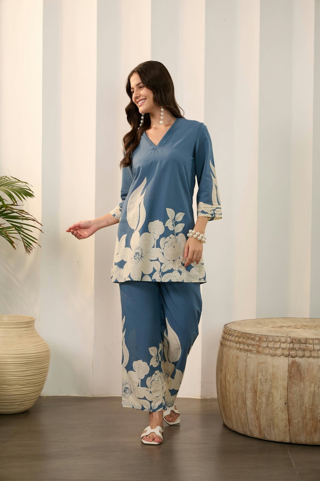 A woman in a blue floral print outfit